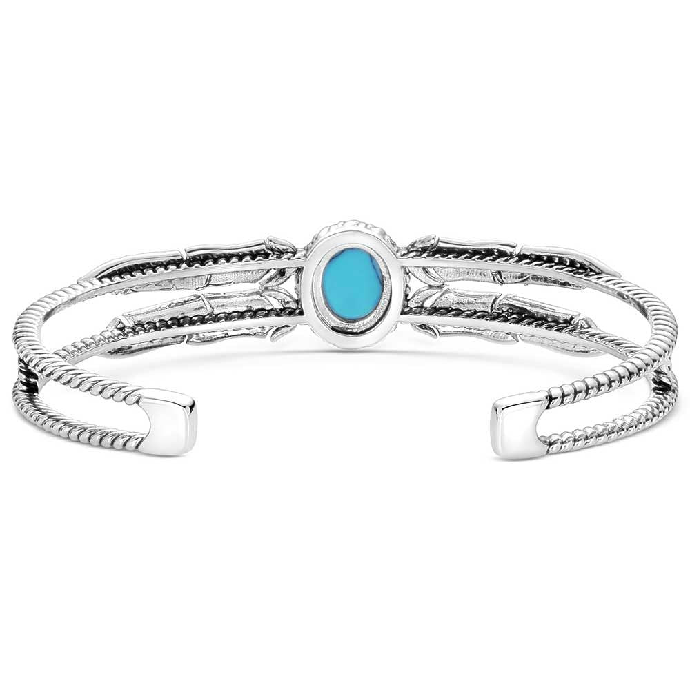 
                  
                    Silver bracelet with a turquoise stone on a white background
                  
                