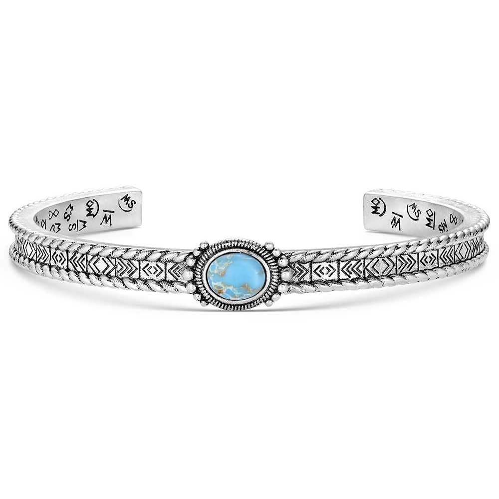 Silver bracelet with a blue gemstone on a white background