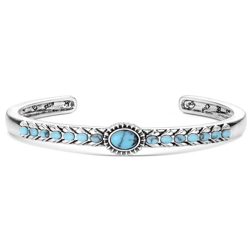 Silver bracelet with turquoise stones on a white background