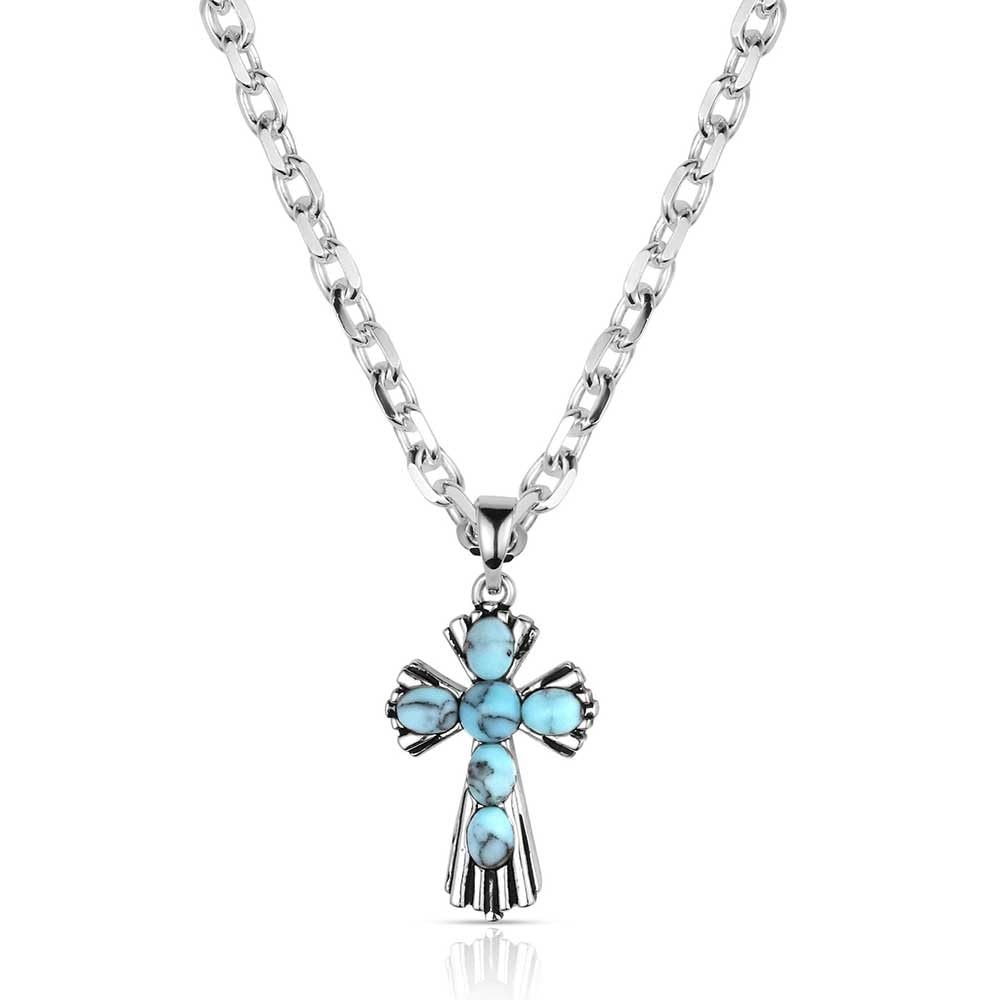 Silver cross necklace with turquoise stones on a white background