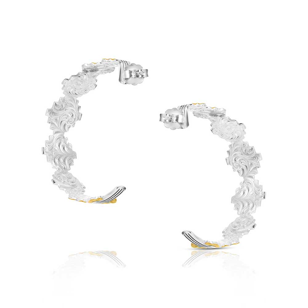 Silver hoop earrings with floral designs on a white background
