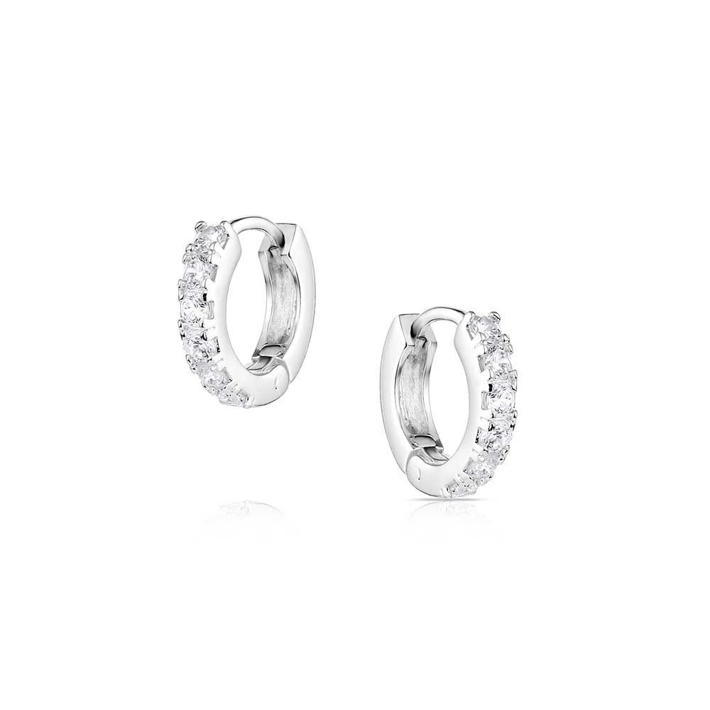 Pair of silver hoop earrings with clear stones on a white background