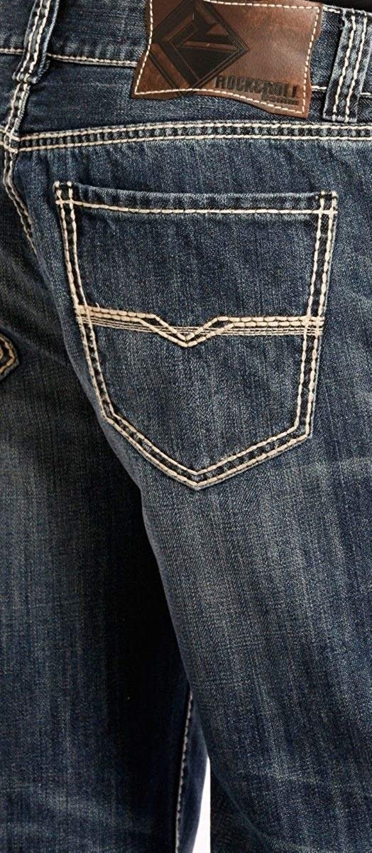 Close-up of a blue denim pocket with a brand label on a dark background