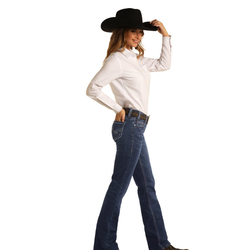 Woman wearing a white shirt, blue jeans, and a black cowboy hat on a white background
