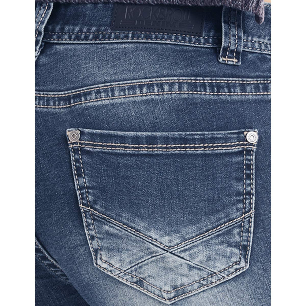 
                  
                    Close-up of a blue denim pocket with a brand label on a white background
                  
                