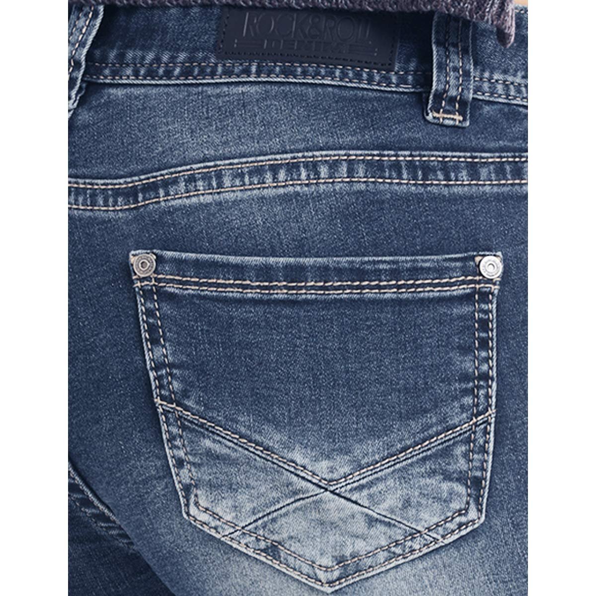 Close-up of a blue denim pocket with a brand label on a white background