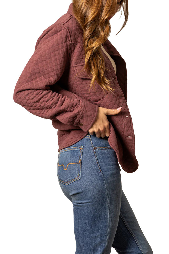 
                  
                    Person wearing a maroon quilted jacket and blue jeans on a white background
                  
                