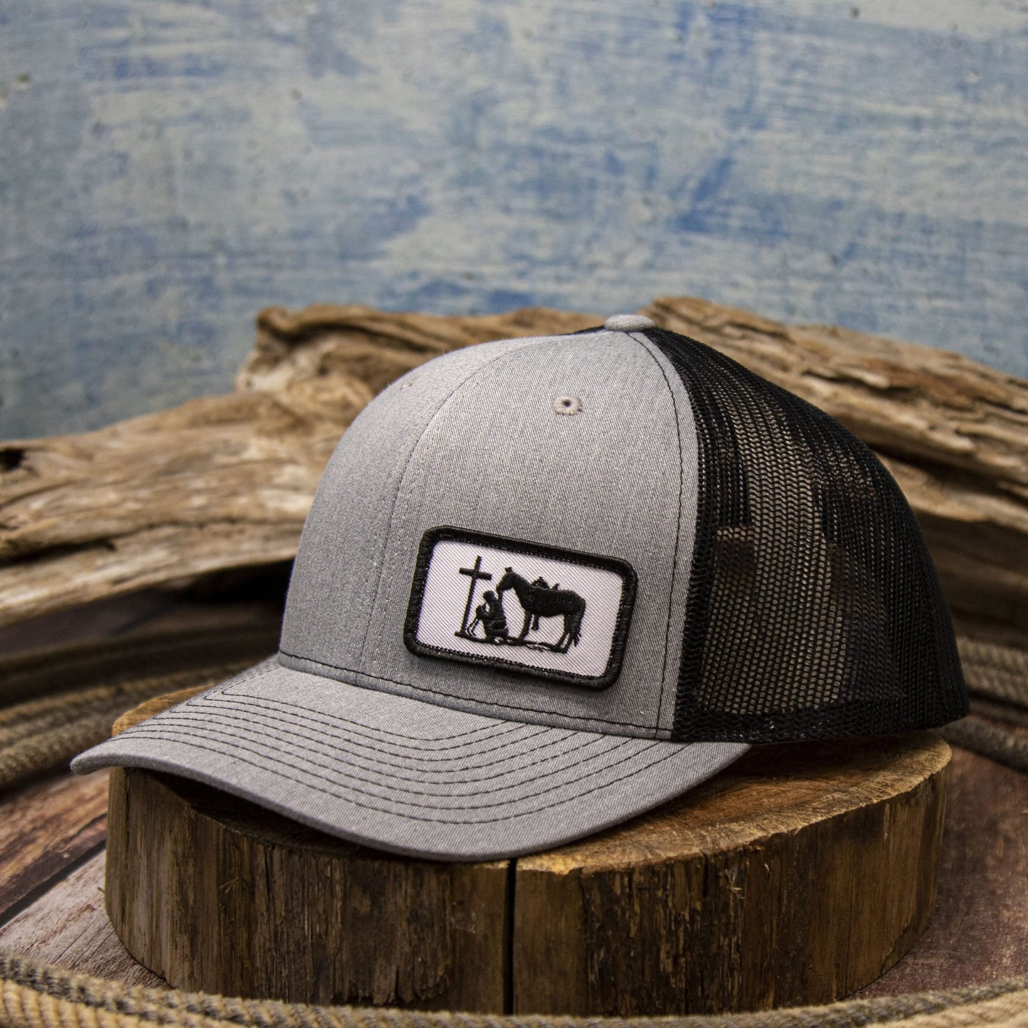 DALLY Up western cap featuring a Christian Praying Cowboy small patch, heather gray front, black mesh back, and adjustable snapback closure.