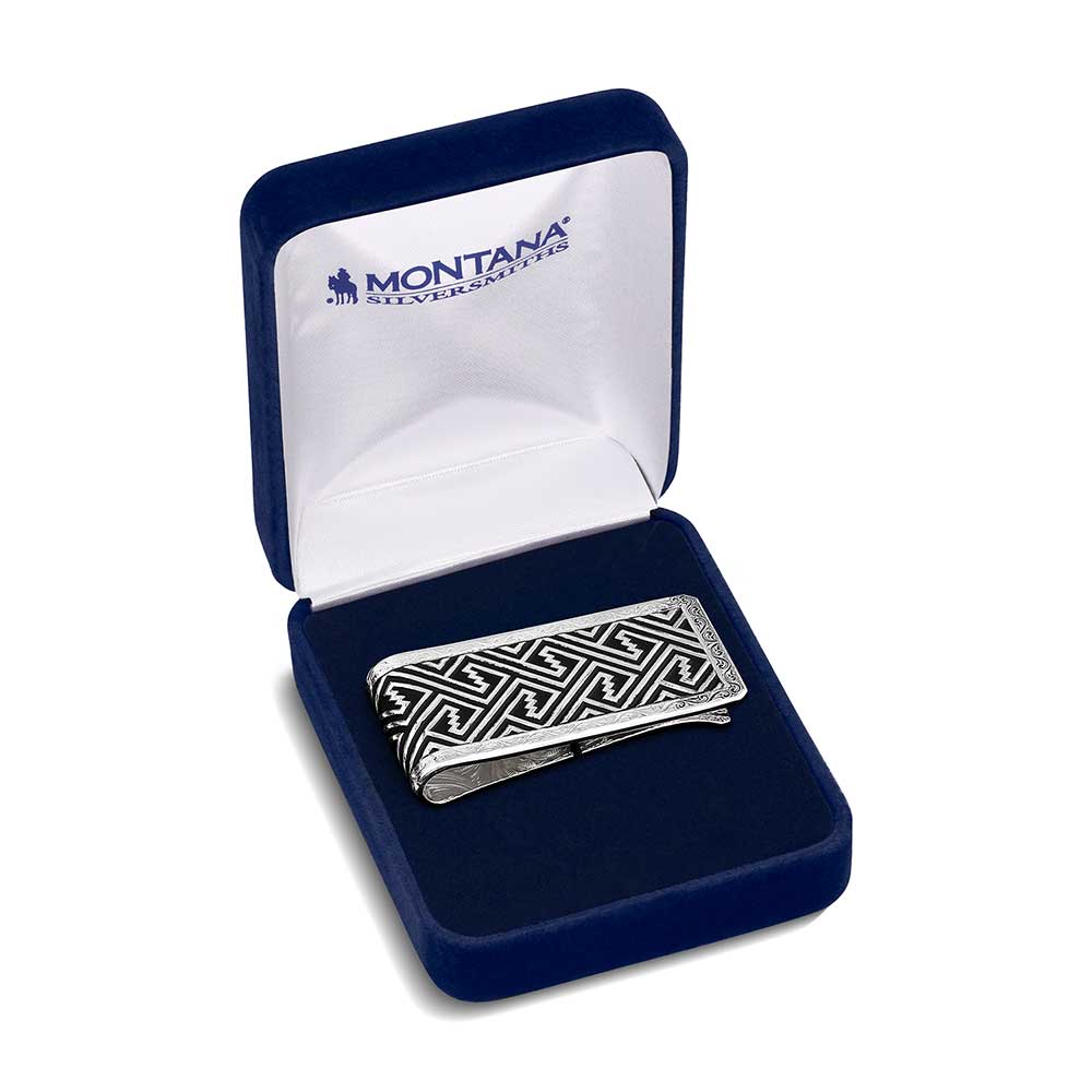 
                  
                    The Custom Desert Twilight Southwestern Money Clip displayed inside a blue Montana Silversmiths gift box, highlighting the contrast between black and silver.
                  
                