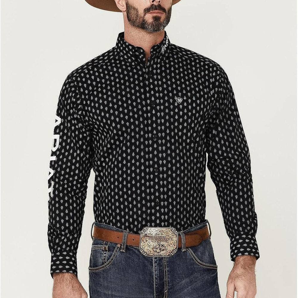 
                  
                    Cowboy Wearing Ariat Men's Team Raine Classic Fit Shirt in Black
                  
                