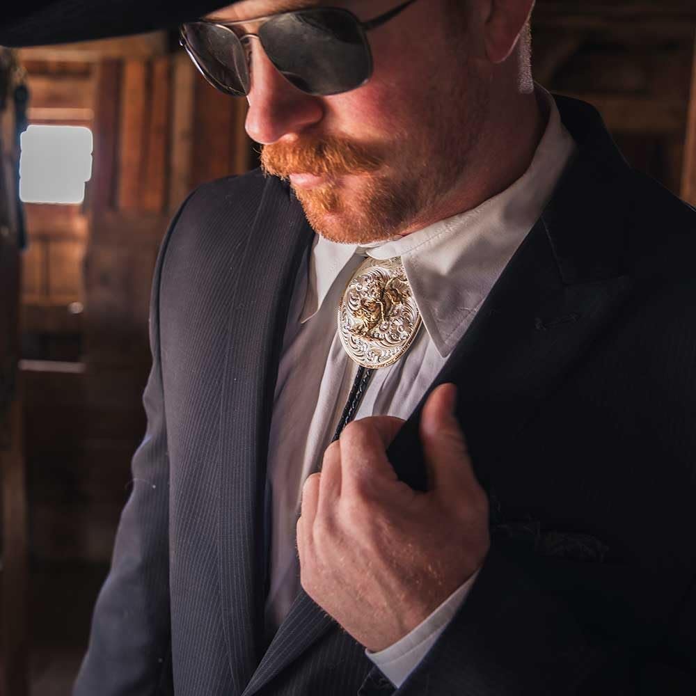 
                  
                    Man Wearing Montana Silversmiths Extra Large Bolo Tie With Bull Rider
                  
                