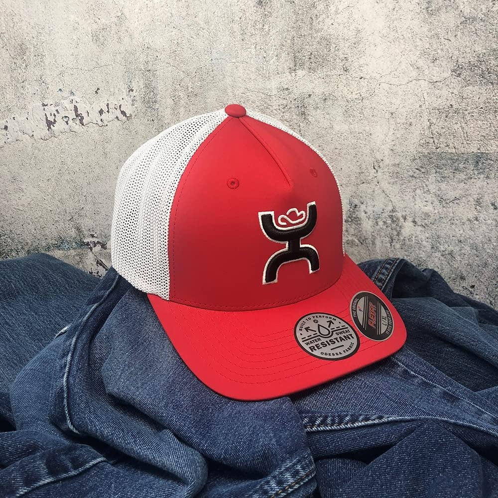 
                  
                    Red and white cap with a logo on a denim surface against a textured gray background
                  
                