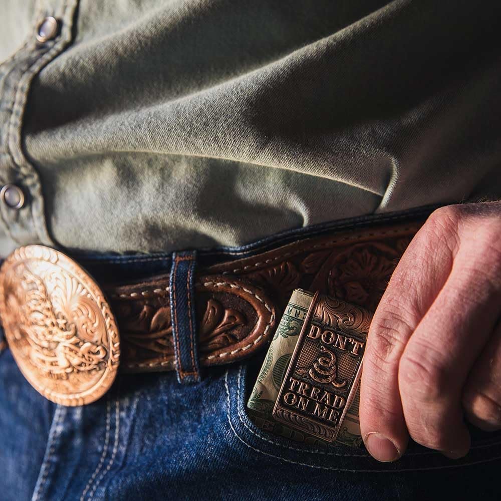 
                  
                    Man Putting Montana Silversmiths Vintage Bronze Gadsden Money Clip in His Pocket
                  
                