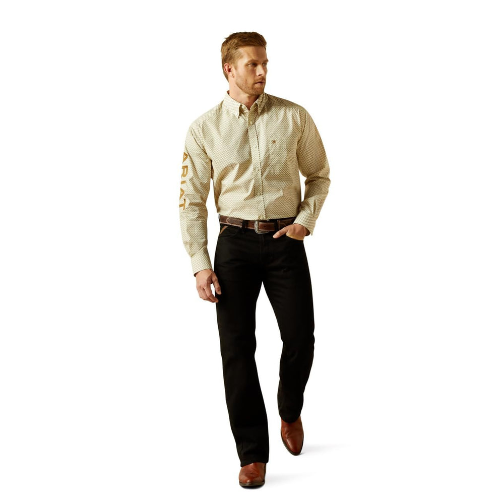 
                  
                    Model wearing Ariat Men's Team Pierce Classic Fit Shirt, Cream/Light Brown
                  
                