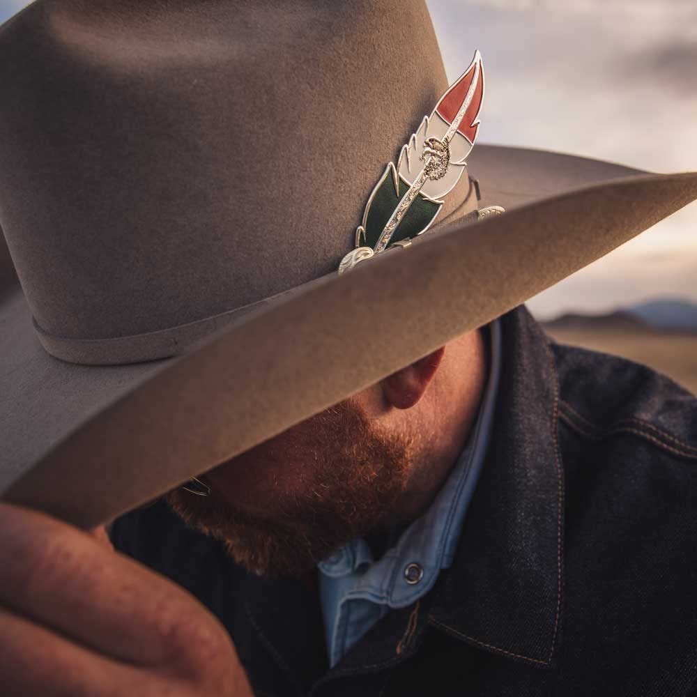 
                  
                    Cowboy Wearing Montana Silversmiths Mexican Pride Hat Feather, Silver
                  
                