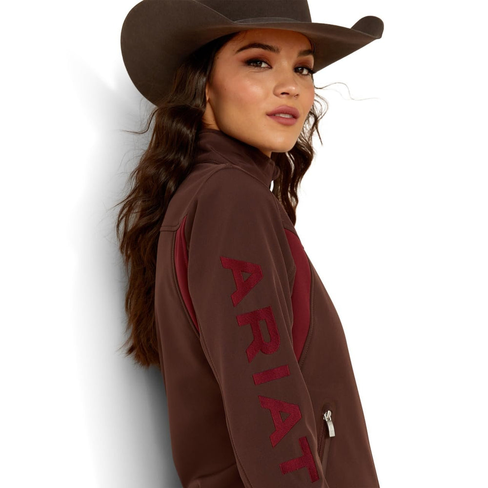 
                  
                    Sleeve Logo of Ariat Women's New Team Softshell Jacket in Chocolate Plum/Tawny Port
                  
                