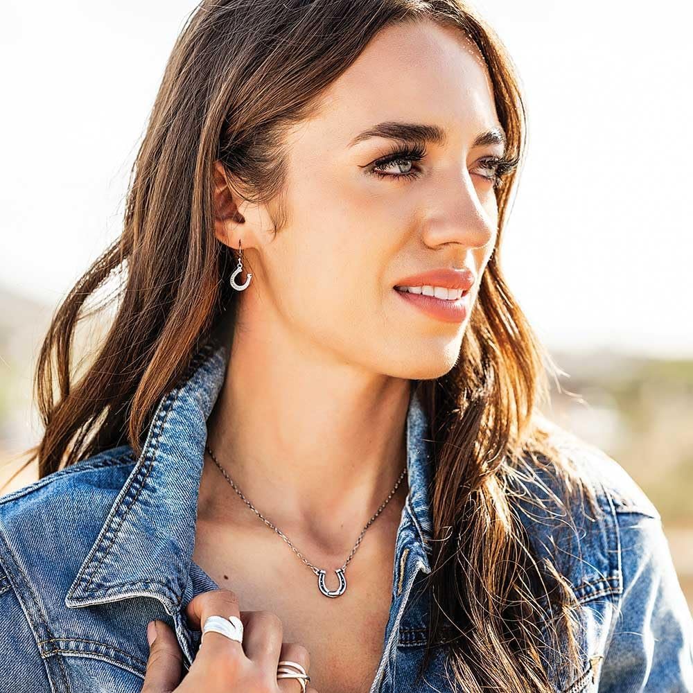 
                  
                    Woman Wearing Montana Silversmiths Women's Dainty Horseshoe Earrings
                  
                