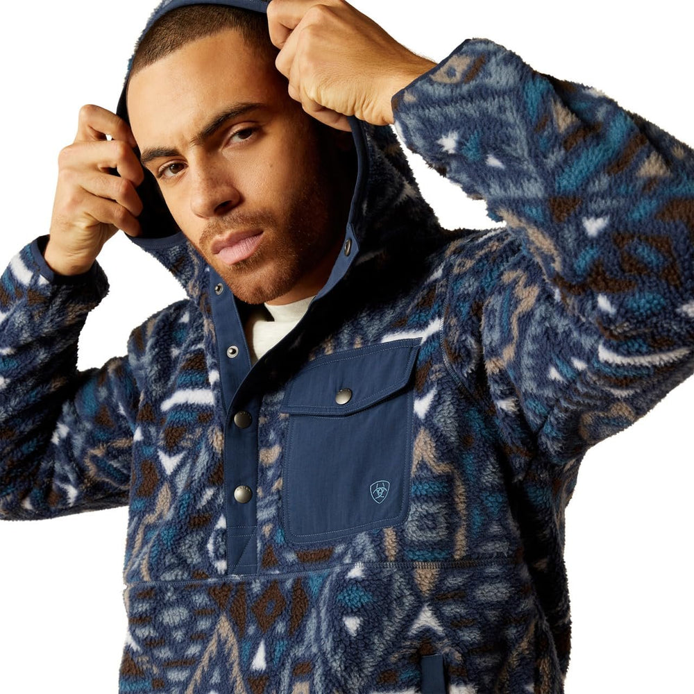 
                  
                    Man Wearing Ariat Men's Polar Bear Fleece Hoodie in Navy Southwest, Pulling Up the Hood
                  
                