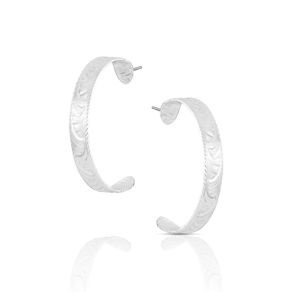 Montana Silversmiths Olivia's Reins Hoop Earrings featuring silver-tone stirrup-shaped hoops with engraved Western scrollwork.