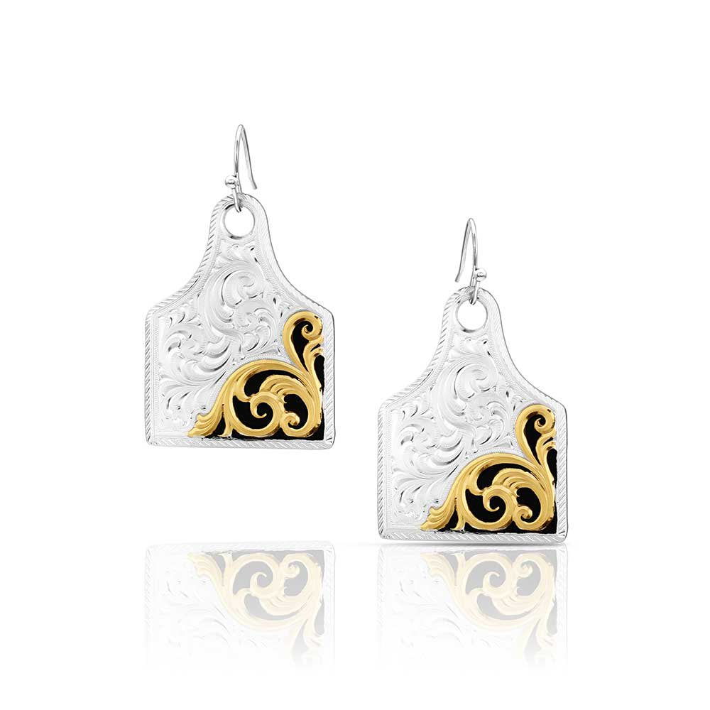 Montana Silversmiths Rural Route Cow Tag Earrings featuring engraved silver-tone cattle tag dangles and USA-made Western craftsmanship.