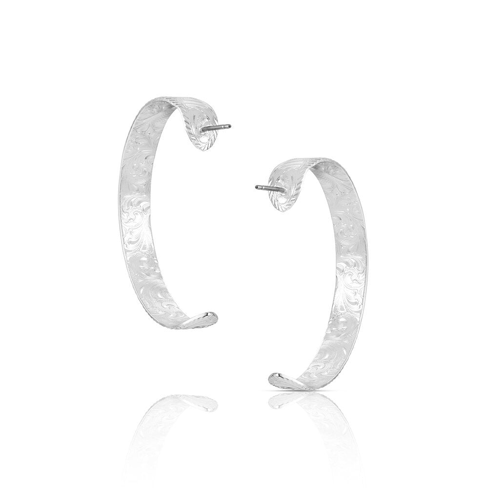 Silver Western stirrup hoop earrings by Montana Silversmiths with blackened engraved details and classic equestrian styling.