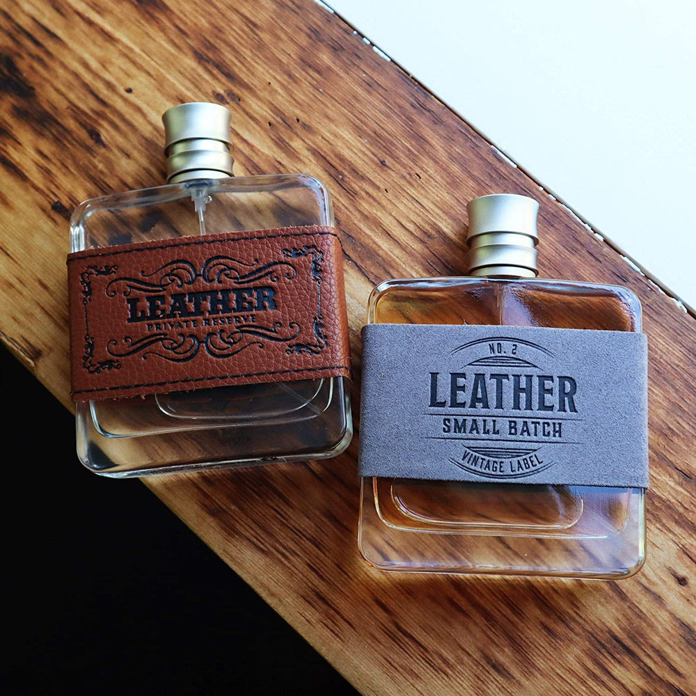 
                  
                    Two Bottles of Tru Western Men's Leather Small Batch Cologne No. 2 Lying on Wood
                  
                