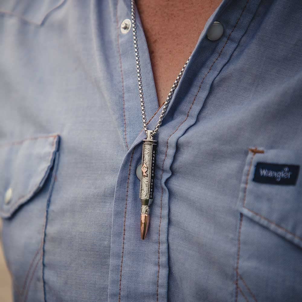 
                  
                    Close-up of Man Wearing Montana Silversmiths Men's I'll Cover You Sniper Bullet Necklace
                  
                