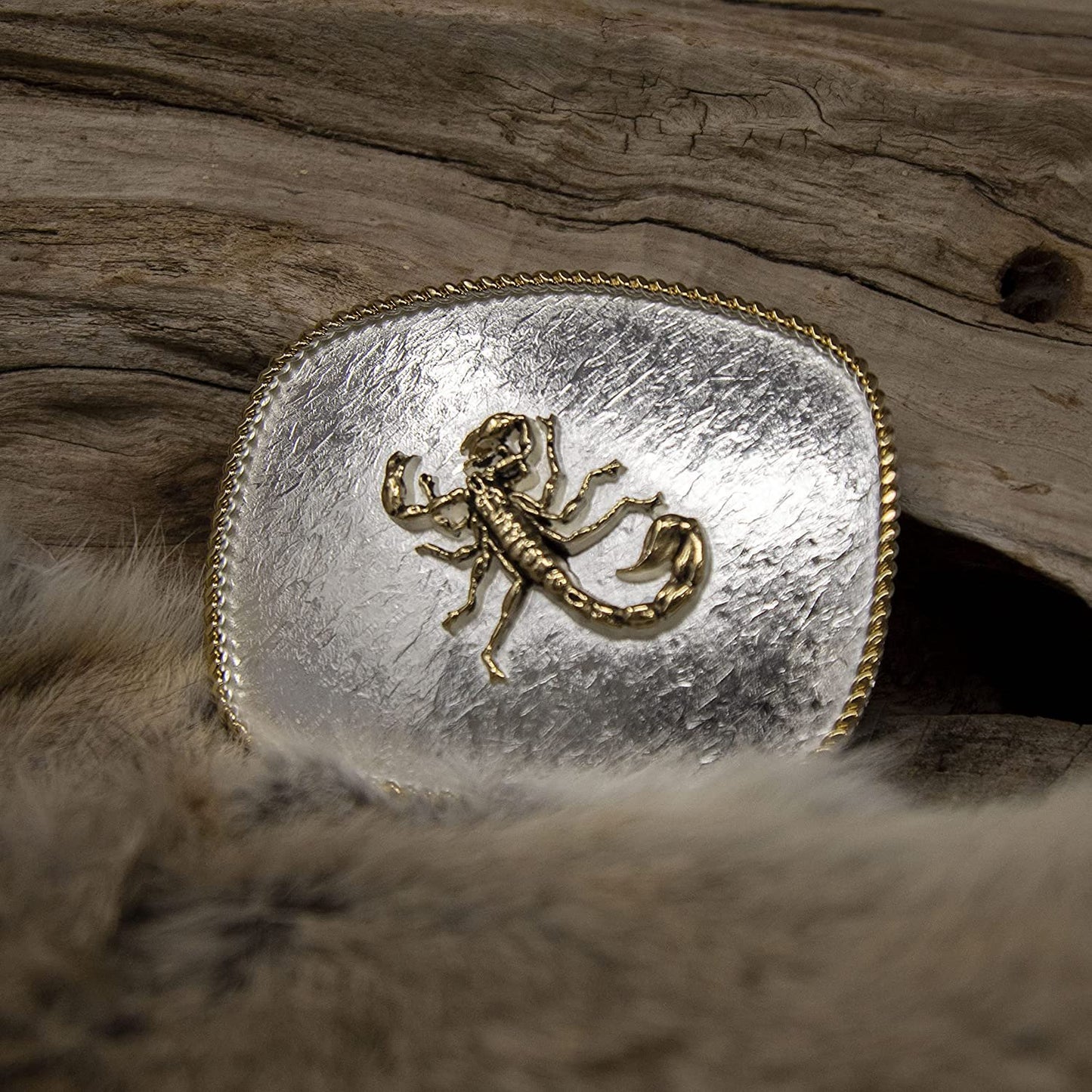 Montana Silversmiths Rippling Waters Scorpion Buckle Against Wooden Background