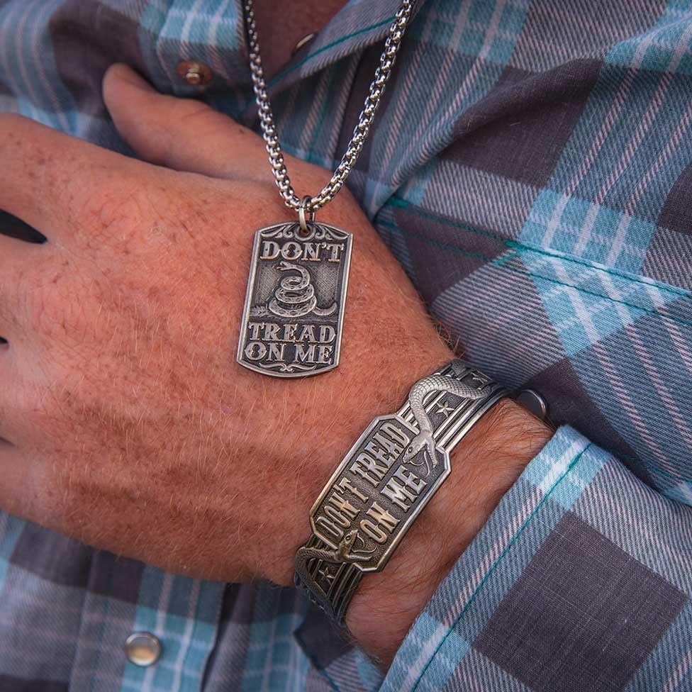 
                  
                    Close-up of Montana Silversmiths Men's Don't Tread On Me Cuff Bracelet and Necklace
                  
                