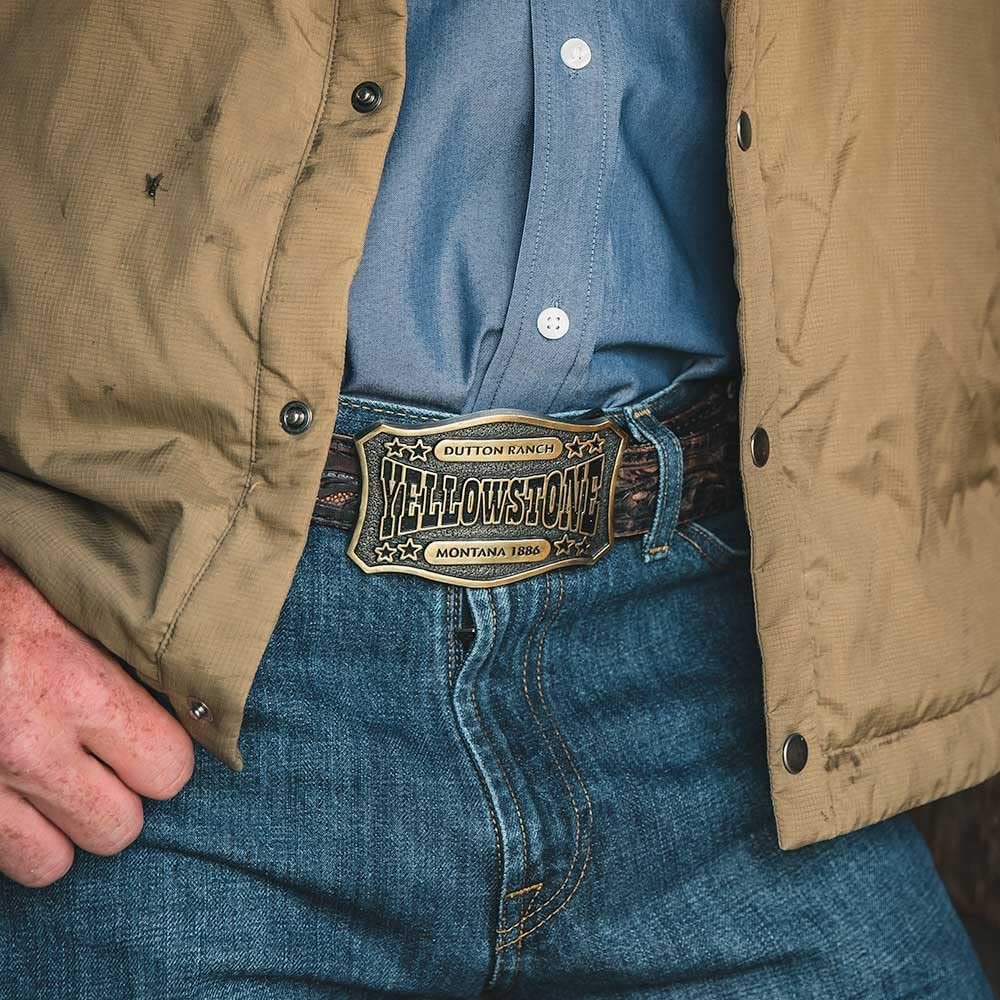 
                  
                    Man Wearing Montana Silversmiths x Yellowstone Collection Belt Buckle, With Dutton Ranch Yellowstone Montana Engraving
                  
                