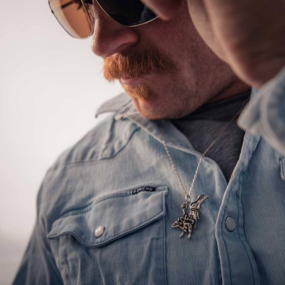Man Wearing Montana Silversmiths Men's Bull Rider Pendant Necklace
