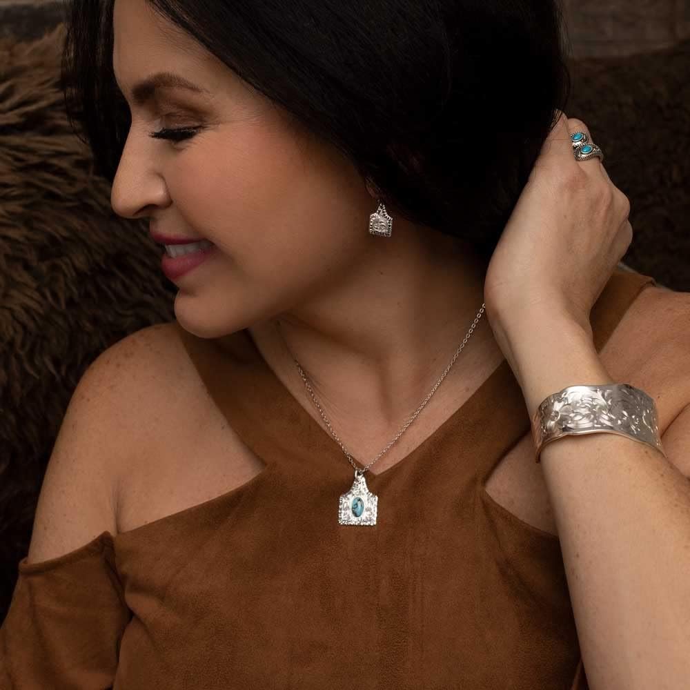
                  
                    Woman Wearing Montana Silversmiths Women's Chiseled Cow Tag Earrings
                  
                