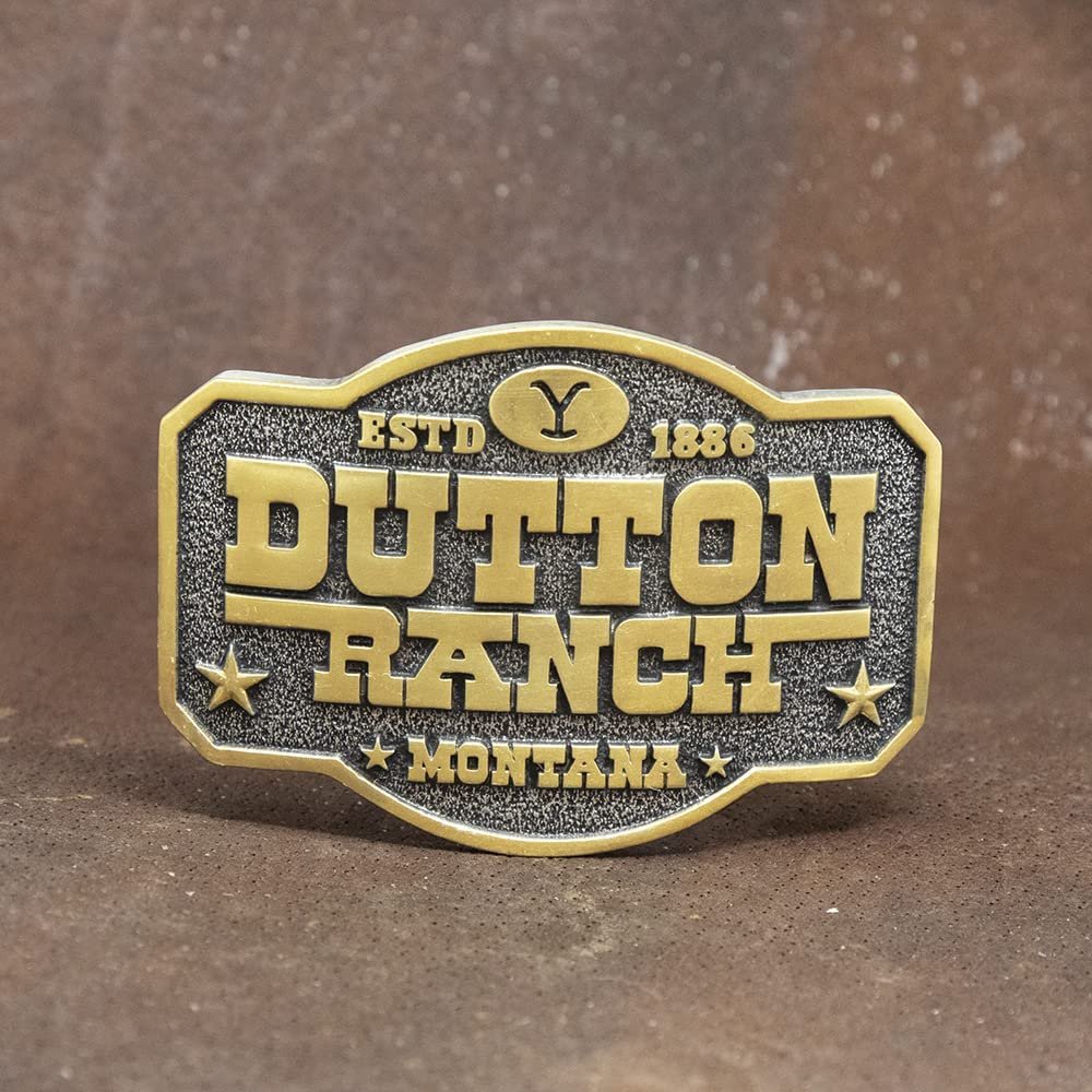 
                  
                    Montana Silversmiths x Yellowstone Collection Belt Buckle, With Dutton Ranch Montana Engraving Against Brown Background
                  
                